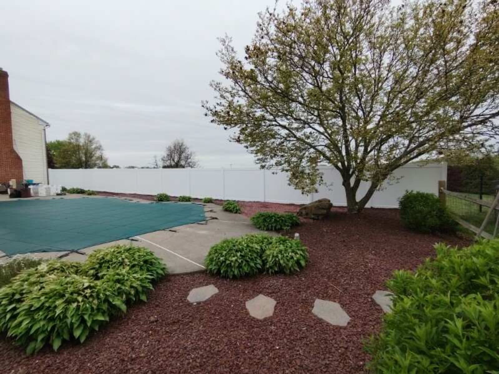 Vinyl privacy fence enclosing a pool and landscaped yard in Bangor, PA