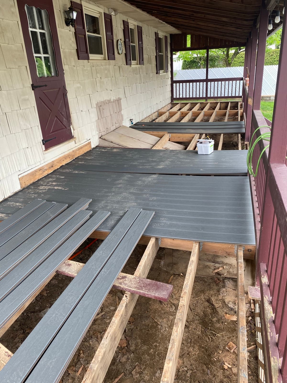 Old deck boards removed and composite boards being installed on the existing frame