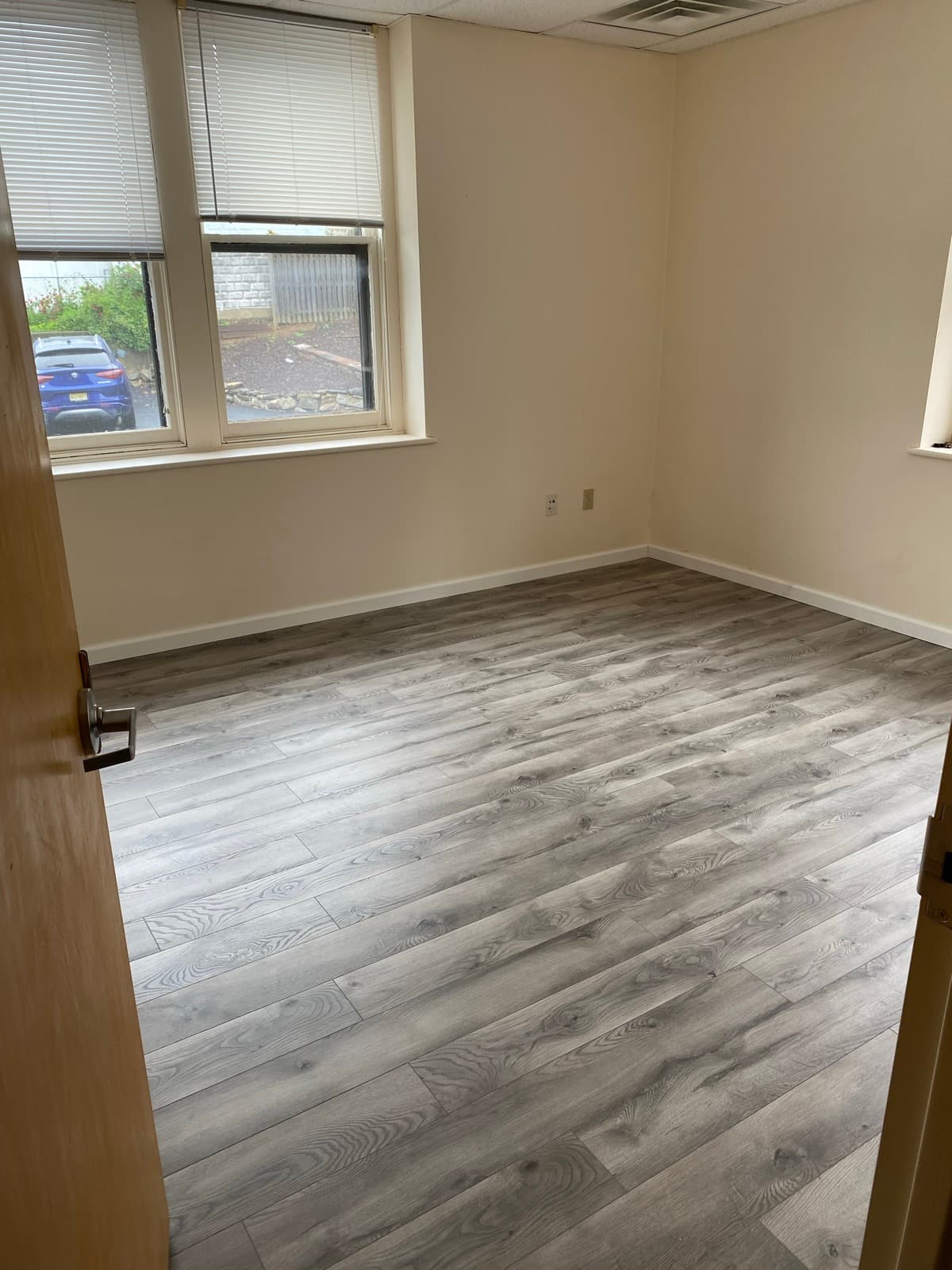 New luxury vinyl plank flooring and white baseboard installed in an Easton, PA office