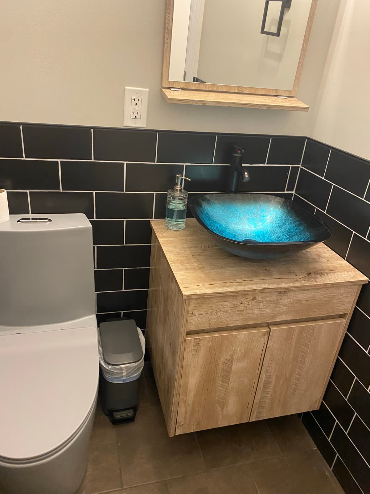 New bathroom in Forks Township, PA with black subway tile and a blue glass vessel sink