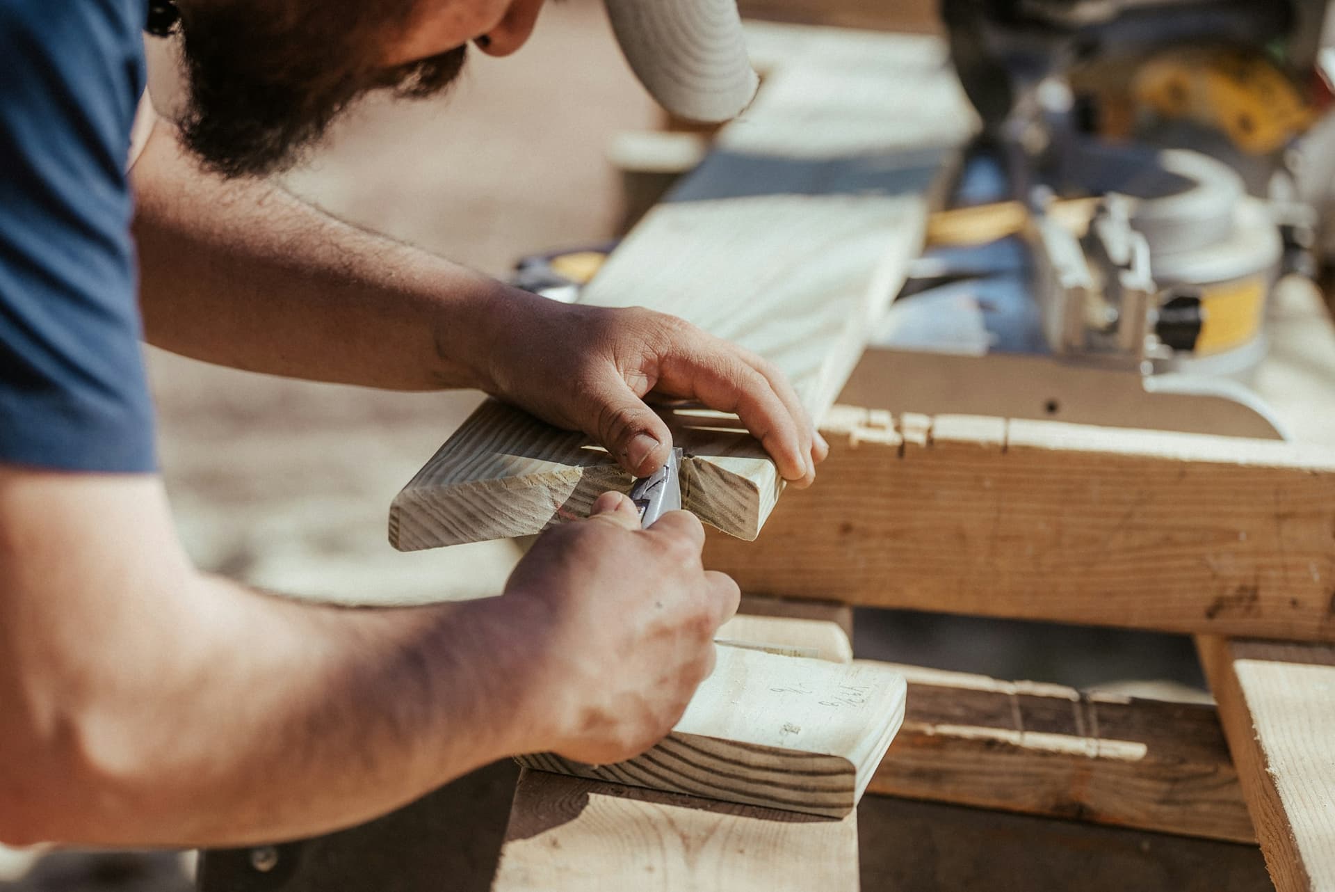 Carpenter marking a wood joint in a workshop
