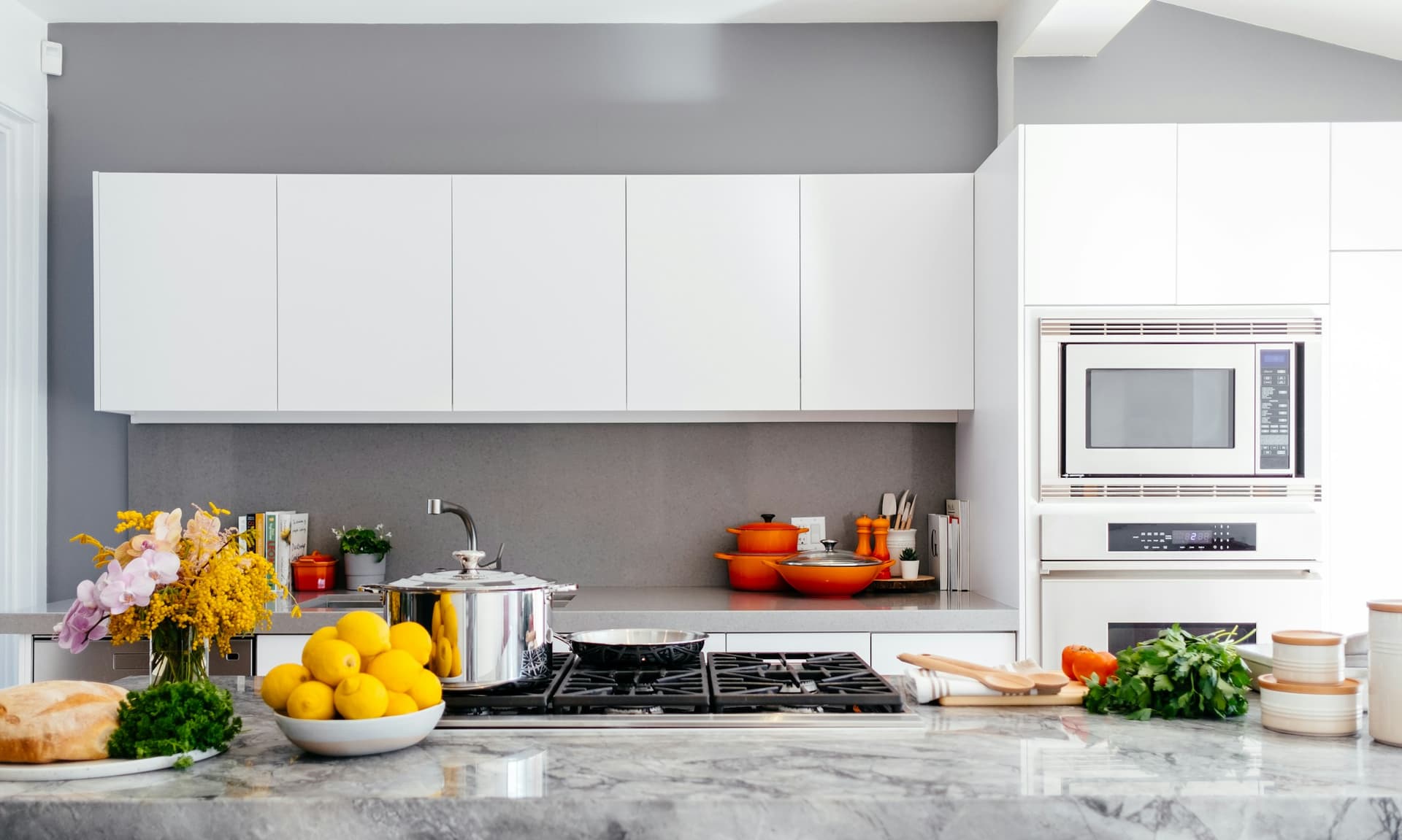 Bright modern kitchen with a marble island and white cabinets